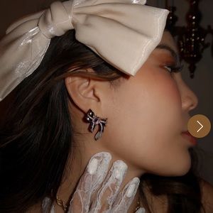 HeyMaeve Elizabeth James silver bow earrings with pink heart stone